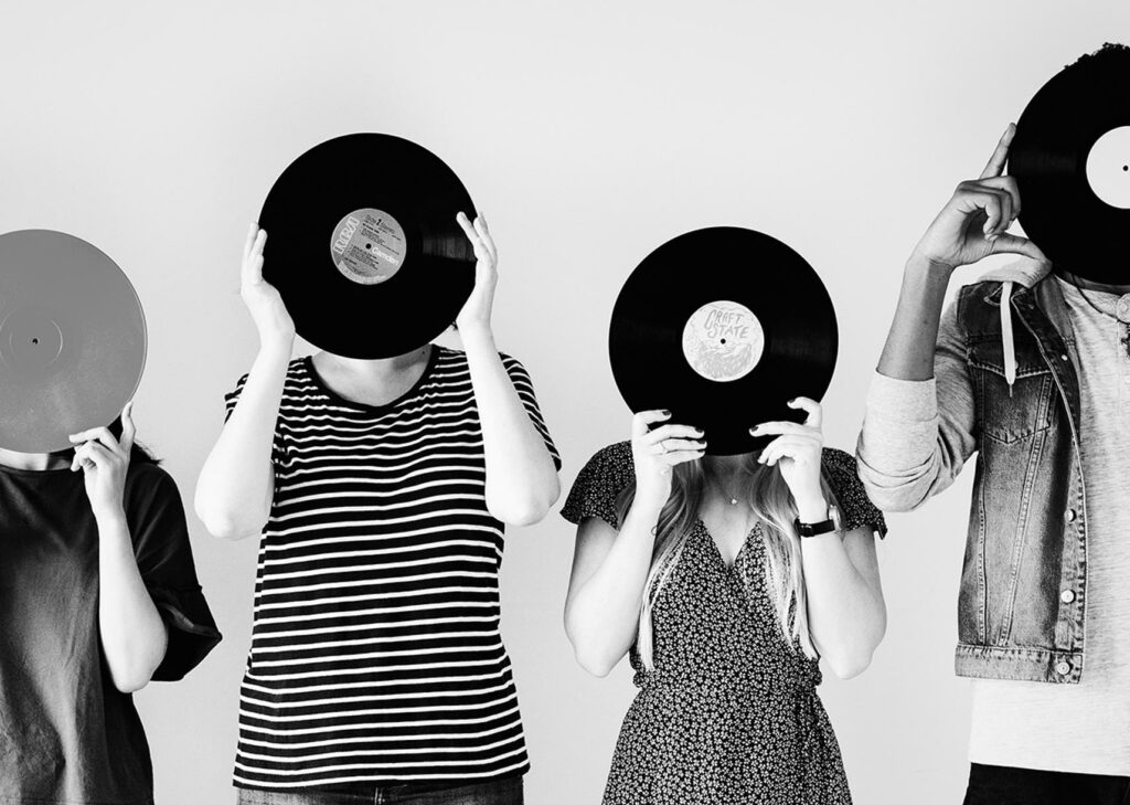 young-friends-covering-their-faces-with-vinyls